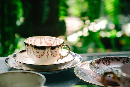 Antique porcelain pastel tea cup on wooden table