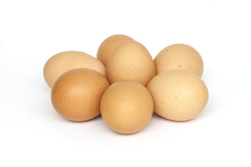 Seven brown eggs isolated on white background