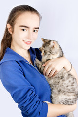 Spotted cat in the hands of a teenage girl