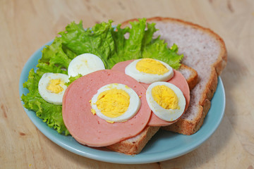 simple breakfast with Sandwich and egg on the wood table