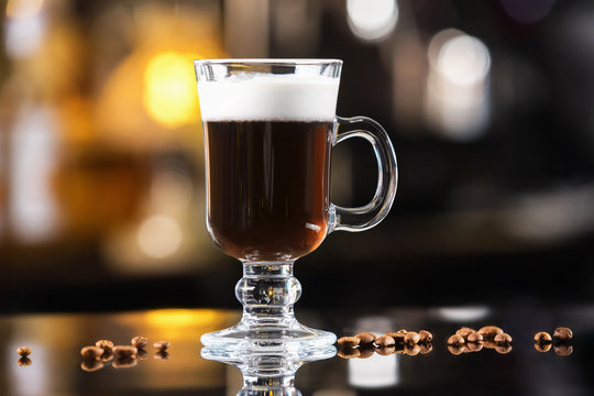 Closeup Glass Of Irish Coffee Cocktail At Bright Bar Counter Background.