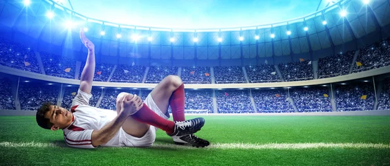 Rolgordijnen Injured football player on stadium field © efks