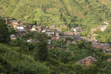 View over traditional Chinese village descending from a hillside 