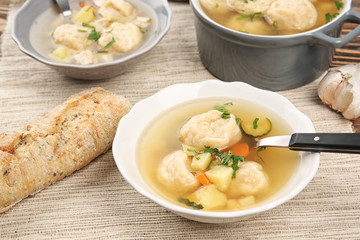 Portions of delicious chicken and dumplings on dining table