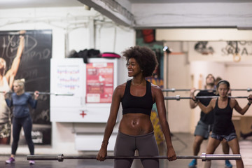 black woman lifting empty bar