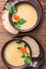 Pea soup in the bowl  on a  rustic wooden background . 