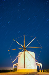 Windmill at night under stars