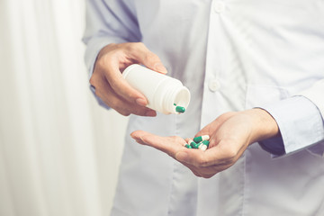 Pill bottle in male doctor hands