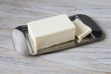 Whole block butter on a wooden background