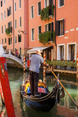 Traditional Gondolas on a narrow canal in Venice, beautiful romantic italian city