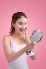 Face of young beautiful healthy asian woman and reflection in the mirror