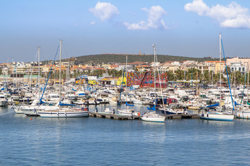 Fototapeta na wymiar Yachts anchored in the port of Alghero, Sardinia