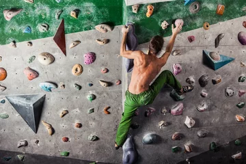 Foto op Canvas man exercise bouldering and climbing indoor © takoburito