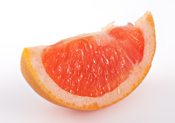 Pieces of pink grapefruit over white background
