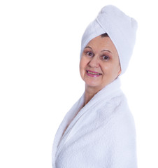 Spa concept. Aged good looking woman with white towel on her head