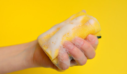 Hand with sponge with foam