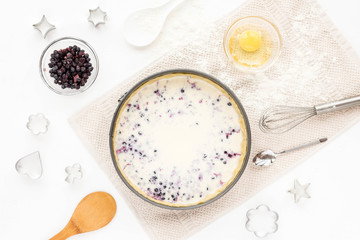 Preparation for cooking tasty berry pie. Baking ingredients on white kitchen background. Top view, flat lay. Summer dessert.