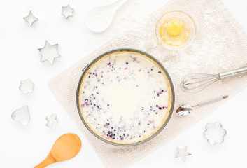 Preparation for cooking tasty berry pie. Baking ingredients on white kitchen background. Top view, flat lay. Summer dessert.