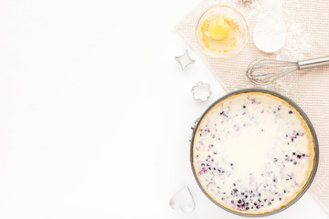 Preparation for cooking tasty berry pie. Baking ingredients on white kitchen background. Top view, flat lay. Summer dessert.