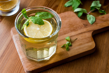 Homemade ice tea with lemon and mint leaves.