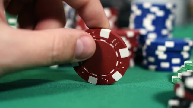 Dealer Hand With Red Poker Chips. Close Up