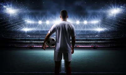 Foto auf Acrylglas Football player with ball on field of stadium © efks
