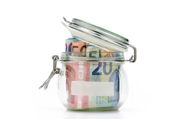 Euro bills in glass jar isolated on white background. Saving money concept.