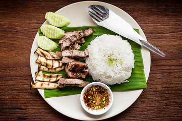 Grilled neck pork and sour sauce with Streamed rice on wood background, Thailand traditional style food