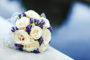 Bridal bouquet of flowers on the background of water