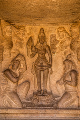 Fototapeta na wymiar Carved rock wall in an ancient Hindu monolithic temple, Pancha Rathas - Five Rathas, Mahabalipuram, Tamil Nadu, India