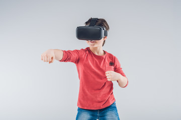Boy using Virtual reality headset on gray