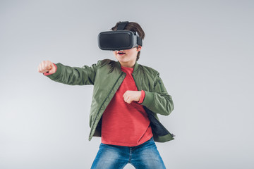 Boy using Virtual reality headset on gray