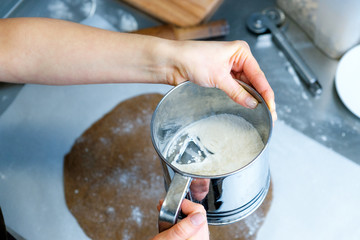 Cake making. Cooking concept. Professional confectioner decorating tasty cake with chocolate frosting