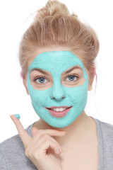 Young beautiful happy smiling young blond girl with face mask over white background