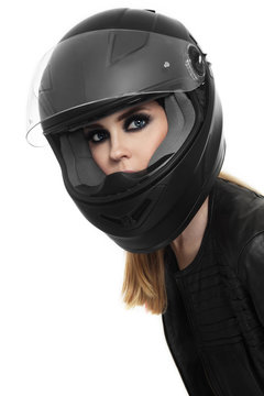 Portrait of young beautiful woman in biker helmet over white background