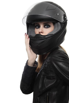 Portrait of young beautiful woman in biker helmet over white background