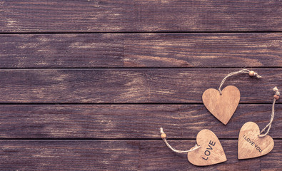 Valentine's day card, heart's on dark wooden background. Flat lay.