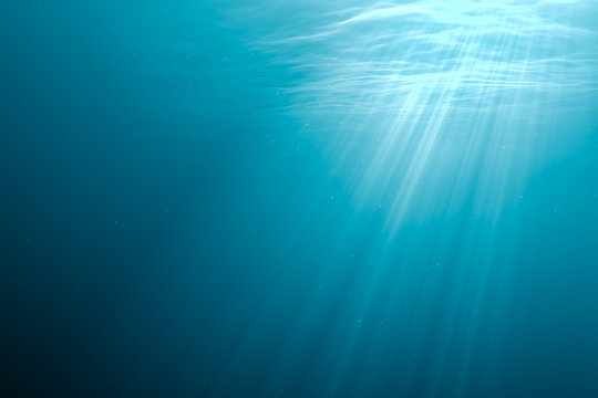 Undersea background. Light rays under water. 3D rendered illustration.