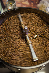 Freshly roasted coffee beans being poured into the cooling down rotator, with motion blur