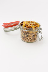 closeup of muesli in a canning jar, isolated on white