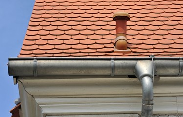Naklejka premium Dachrinne, Regenfallrohr und Schneefang am Dach