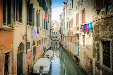 Fototapeta na wymiar Narrow Canal Street in Venice with Washing Hanging on Line