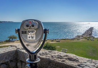 Seascape with Binoculars in Foreground and Breakwater in Background
