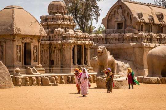 Hindu women visiting ancient Hindu monolithic,  Pancha Rathas - Five Rathas, Mahabalipuram, Tamil Nadu, India