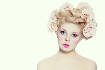 Naklejka premium Young beautiful blue-eyed girl with fancy hairdo and make-up over white background
