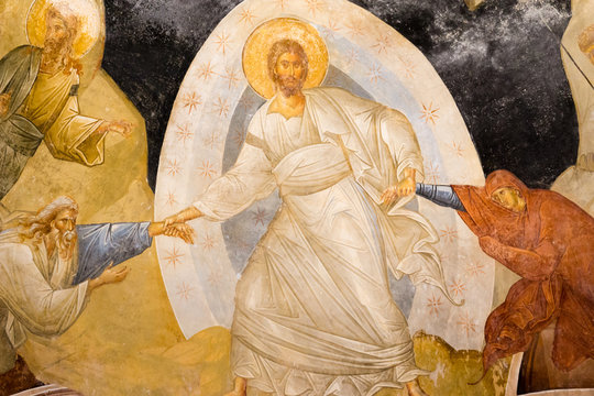 Christ standing in a mandorla, pulling Adam and Eve from the underworld, an old fresco of the resurrection, the anastasis in Chora church. 