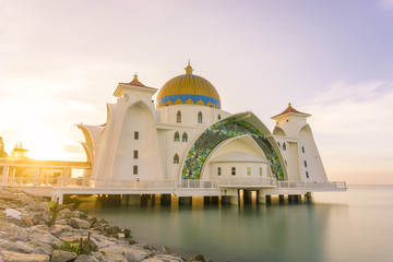 A mosque in Malacca, Malaysia that built near seascape, sunrise with colorful sky 