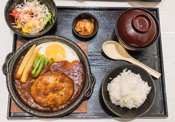 pork burger with fried egg in hot plate