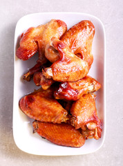 Flying chicken wings on plate