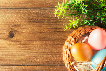 Basket of easter eggs on wooden table